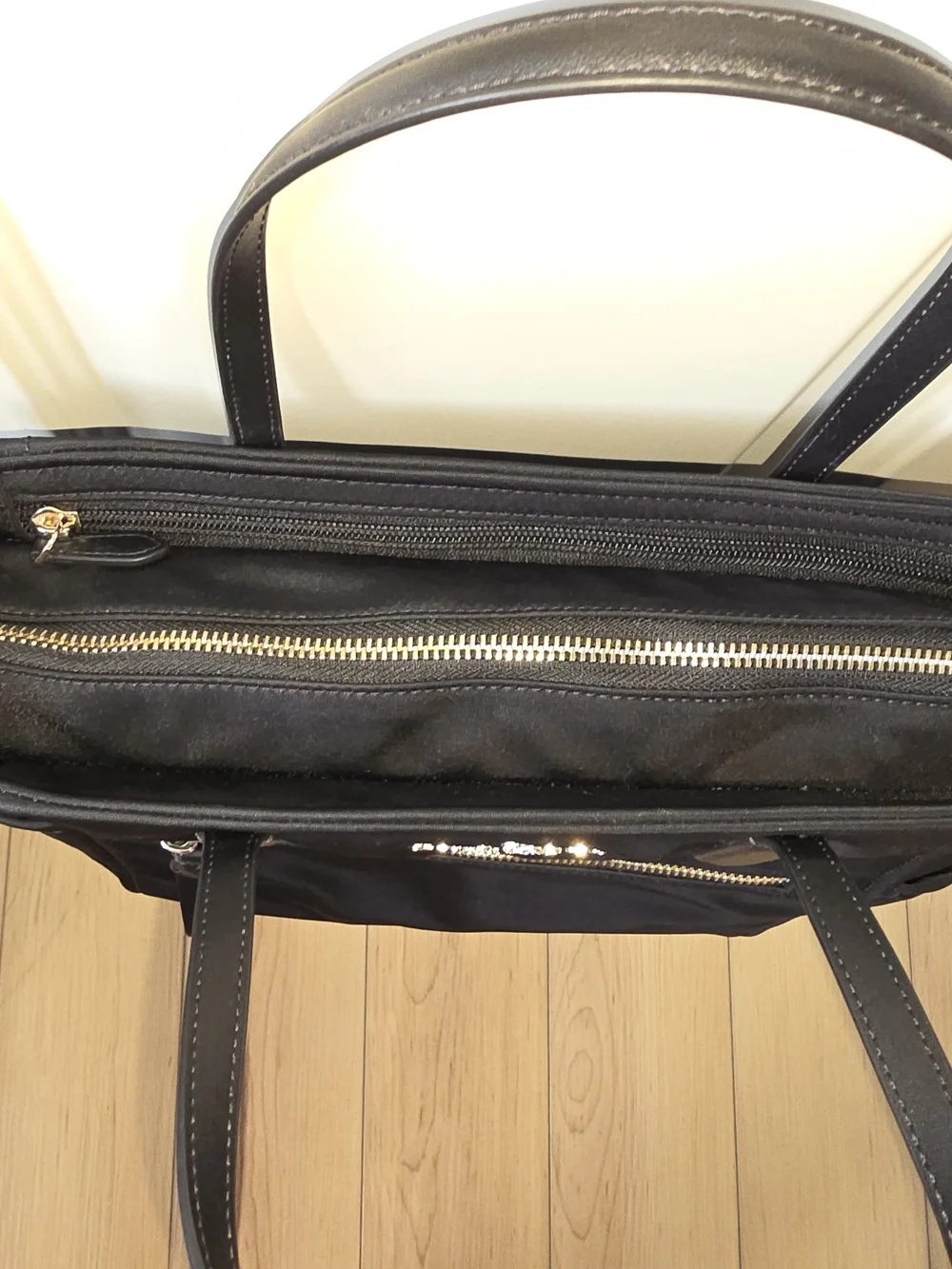 kate spade black tote with gold-tone logo and zipper